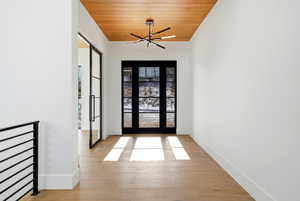 Foyer entrance with wood ceiling and light wood finished floors