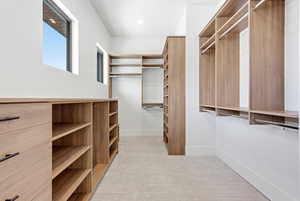 Walk in closet with light carpet