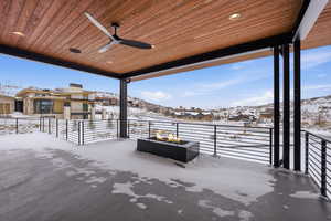 Snow covered patio featuring a ceiling fan, a patio, and a mountain view