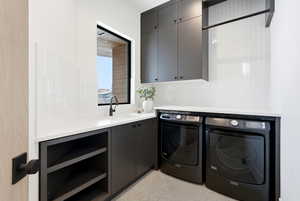 Laundry room featuring cabinet space and washing machine and clothes dryer