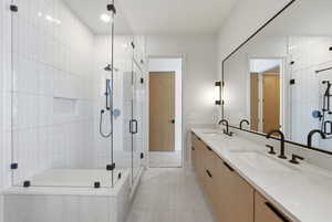 Full bath featuring double vanity, a shower stall, light tile patterned floors, and recessed lighting