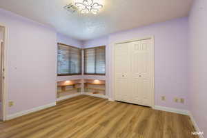 Unfurnished bedroom featuring light wood-style flooring