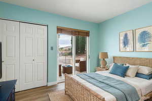 Bedroom featuring access to outside, a closet, and light wood-type flooring