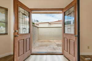 Primary bedroom private entryway from private courtyard with wood finished floors