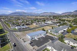 Aerial overview of property's location with a mountainous background and nearby suburban area