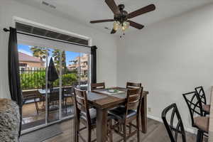 Dining area with wood finished floors and ceiling fan