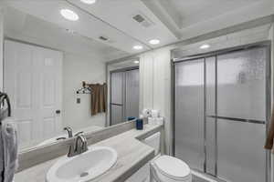 Bathroom featuring a shower stall, vanity, and recessed lighting
