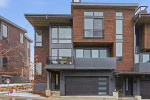 Contemporary house featuring a balcony and an attached garage
