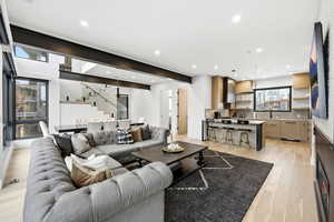 Living room with light wood-style floors and recessed lighting