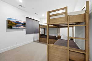 Bedroom featuring light colored carpet and baseboards
