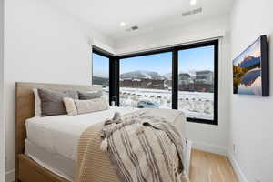 Bedroom with light wood-style floors and recessed lighting