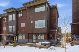 Snow covered property featuring a view of apartment building / complex