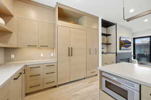 Kitchen featuring open shelves, modern cabinets, light wood finish cabinetry, and recessed lighting