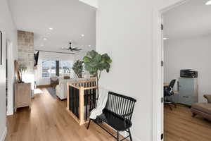 Corridor with recessed lighting, light wood-style floors, and an office area