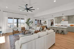 Living area featuring ceiling fan, light wood-style floors, and recessed lighting