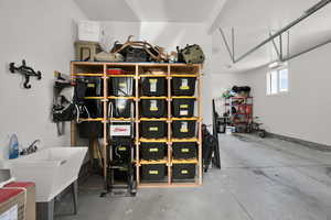 Garage featuring a sink and baseboards