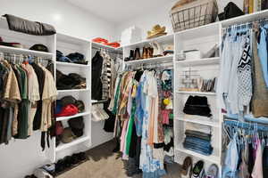 Walk in closet with carpet