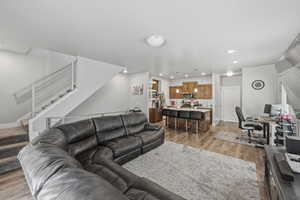Living area featuring a desk, light wood finished floors, and recessed lighting