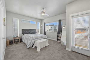 Carpeted bedroom featuring a ceiling fan and baseboards