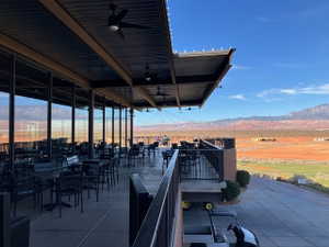 View of patio / terrace with ceiling fan and a mountain view