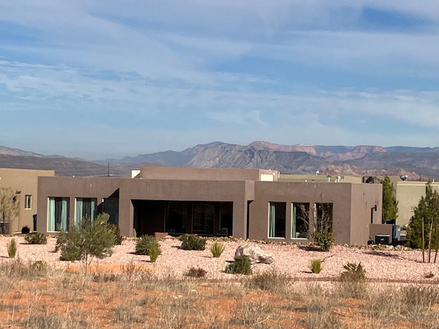Back of house featuring a mountain view, stucco siding, and a patio area