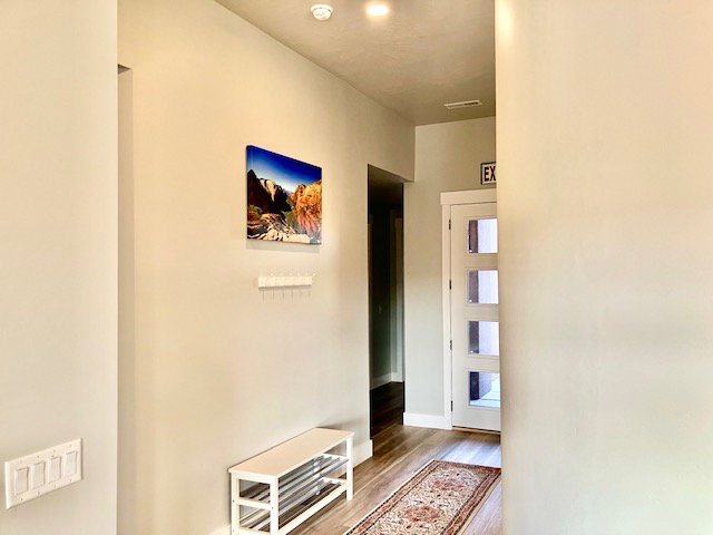 Hallway featuring light wood-style floors and baseboards