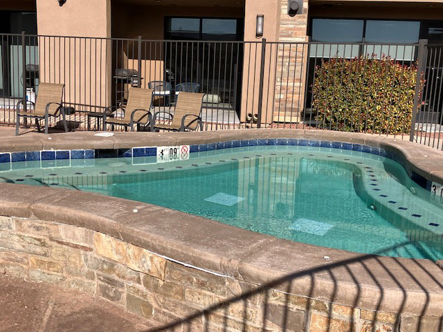 View of pool with a swimming pool and patio surround