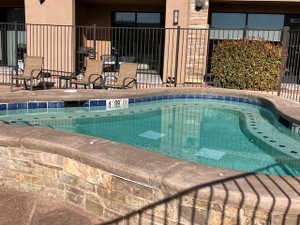 View of pool with a swimming pool and patio surround