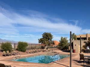 Community pool with a patio and a mountain view