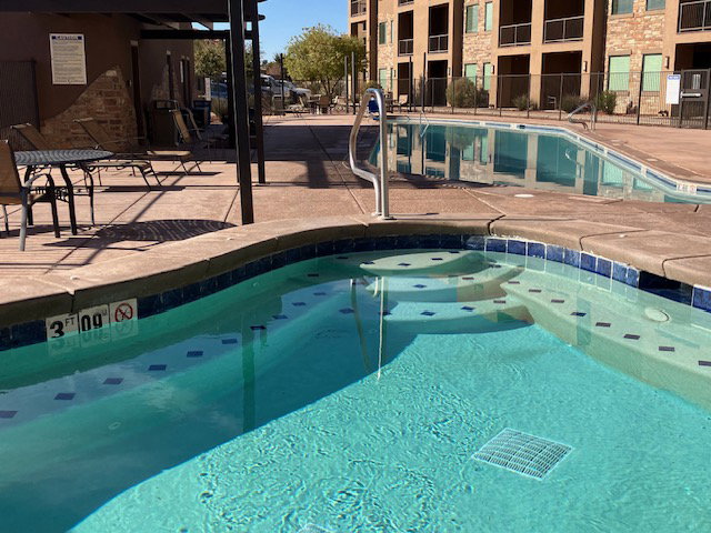Community pool featuring a patio and a community hot tub