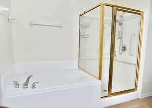 Full master bath with a stall shower and a garden tub