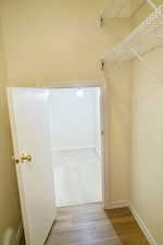 Storage closet or kid's play area with wood finished floors