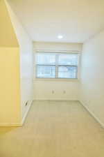 Bedroom cubby  with light colored carpet and recessed lighting