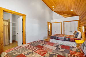 Bedroom featuring a vaulted wood ceiling, multiple closets, and recessed lighting