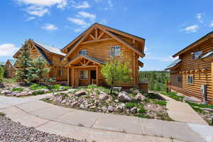Log home with log exterior and a metal roof