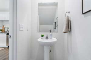 Bathroom featuring a sink and wood finished floors