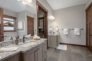 Bathroom featuring two vanities and a closet