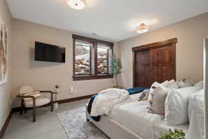 Carpeted bedroom featuring baseboards