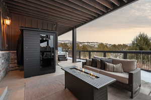View of patio / terrace with a fire pit and a mountain view
