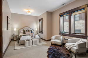 Carpeted bedroom with baseboards