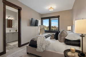 Bedroom with carpet flooring and ensuite bathroom
