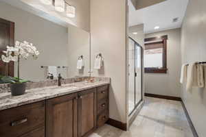 Full bath featuring vanity, a shower stall, and recessed lighting