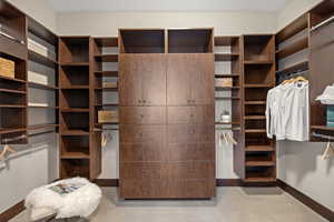 Walk in closet featuring light colored carpet