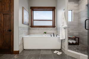 Full bathroom featuring a garden tub and a stall shower