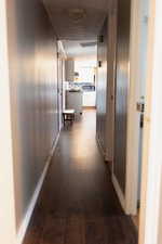 Corridor featuring dark wood-style floors
