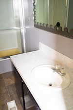 Bathroom featuring vanity and a shower with shower door