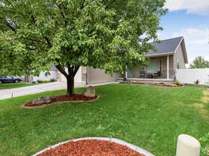 Obstructed view of property featuring stone siding, driveway, a shingled roof, and an attached garage
