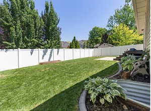 Fenced backyard with a patio area