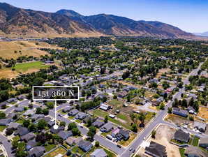 View of property location featuring property parcel outlined, a mountainous background, and nearby suburban area