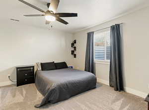 Bedroom with light carpet and ceiling fan
